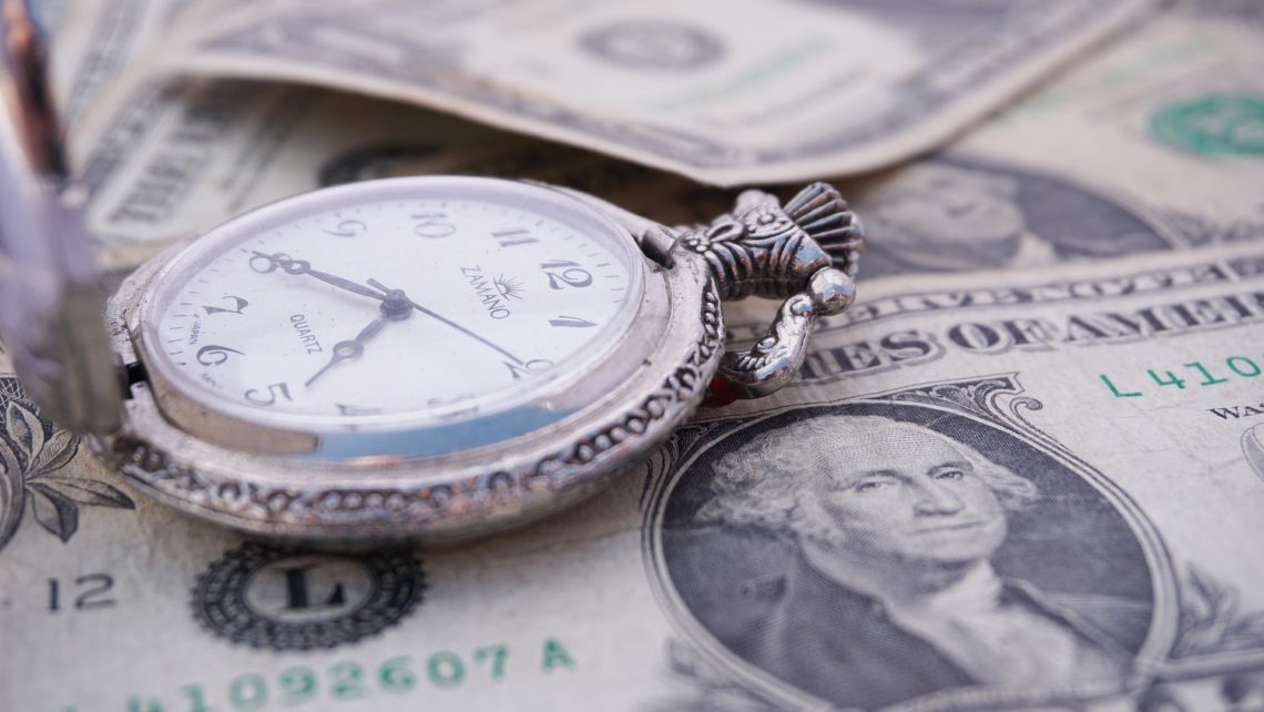 Pocket watch on a pile of money, representing time is money. Time spent on SPCC inspections saves money in the long run.