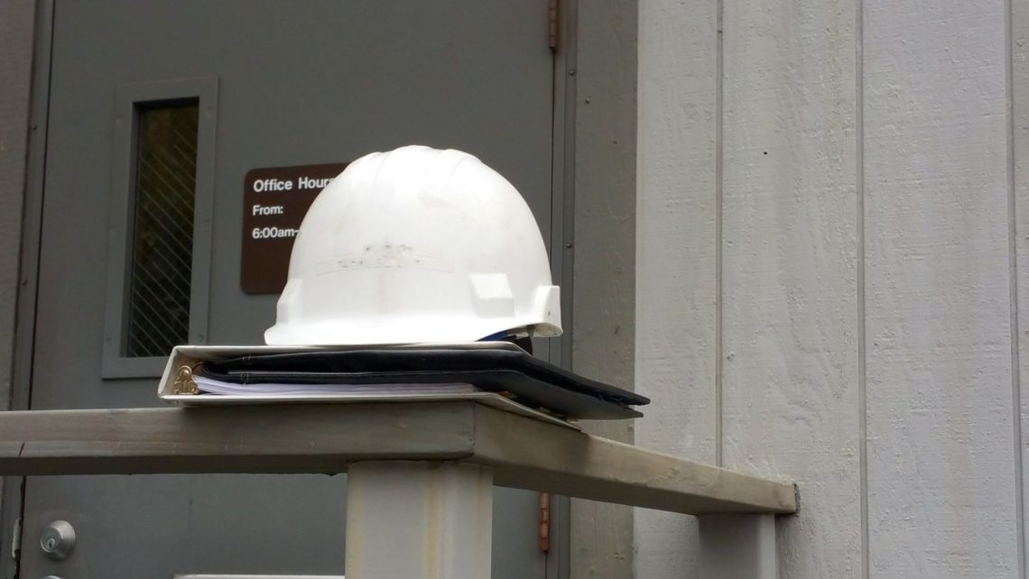hardhat on a binder outside of a workplace for an OSHA inspection