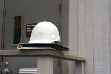 hardhat on a binder outside of a workplace for an OSHA inspection