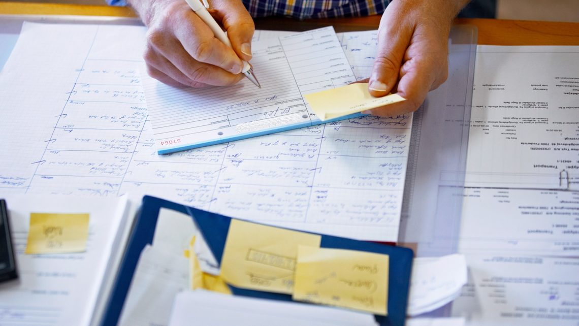 business man writing on notebook list productivity