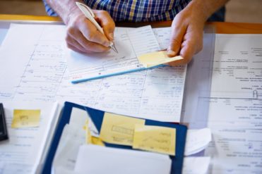 business man writing on notebook list productivity