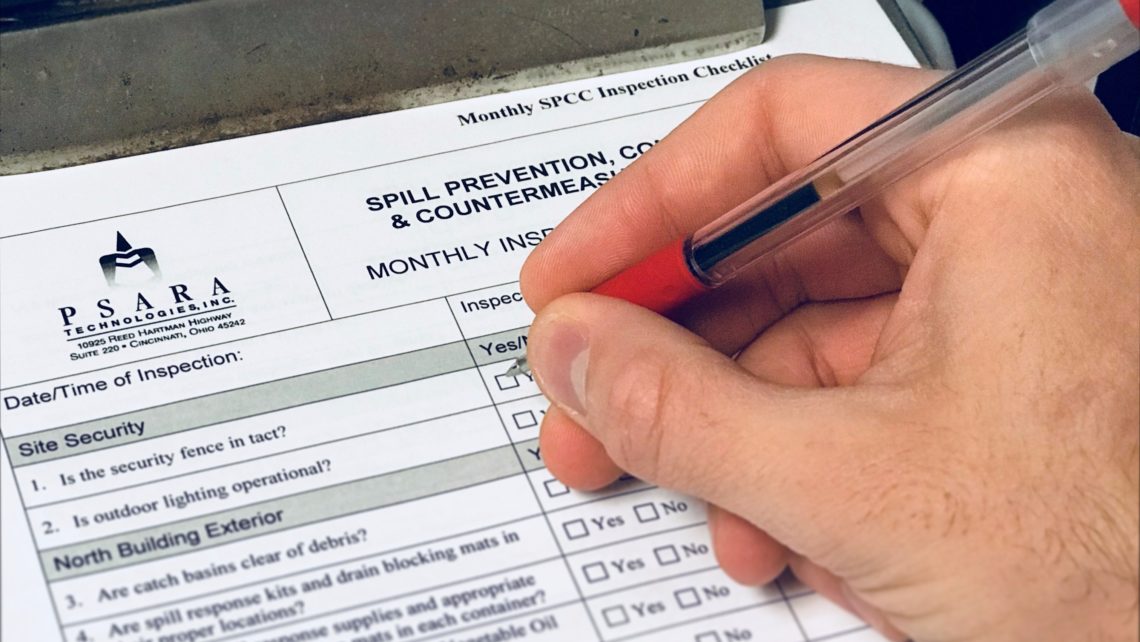 a person is filling out a monthly spill prevention checklist