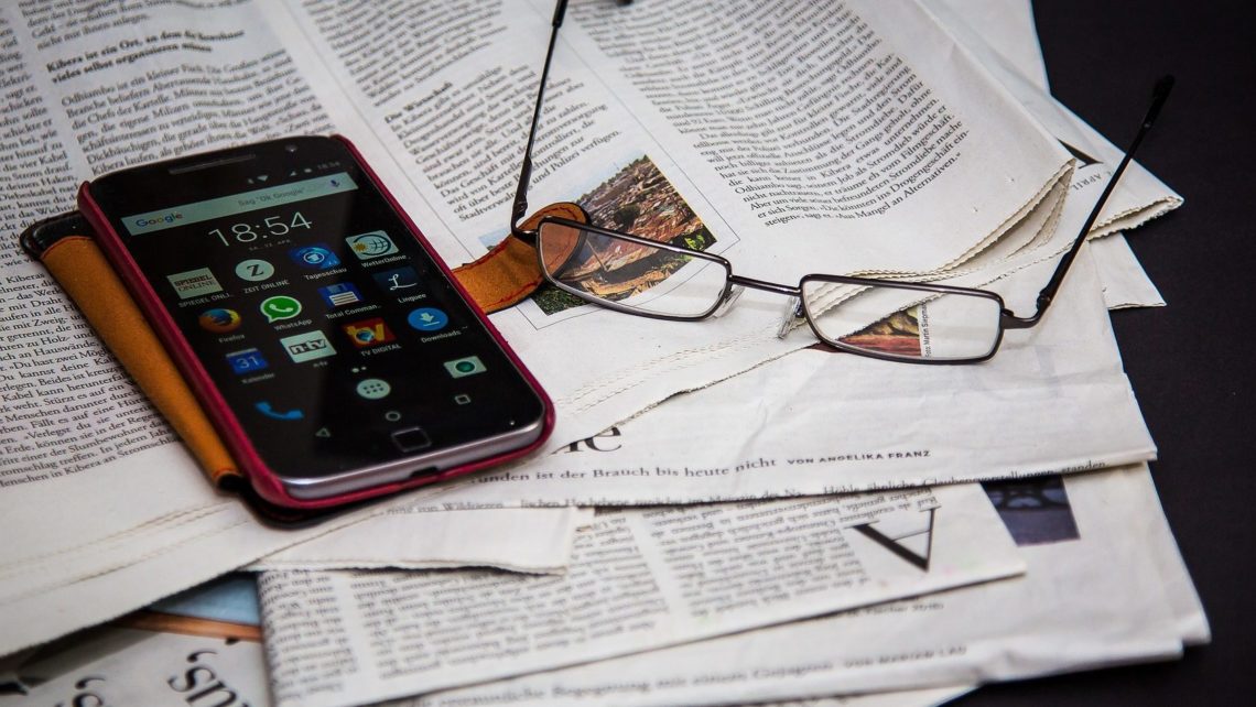 Newspapers, glasses, and phone splayed on a table indicated an attempt to keep up with EHS Blogs and news.